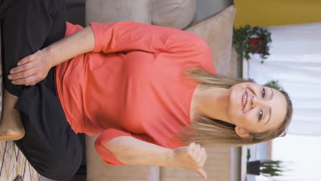 Vertical-video-of-The-woman-promoting-is-pointing-to-the-side-and-laughing.